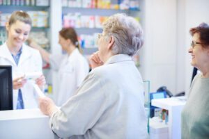 A woman is standing in front of some shelves.