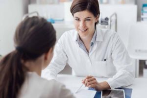 A woman consulting other woman wearing white