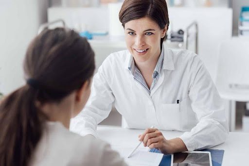 A woman consulting other woman wearing white