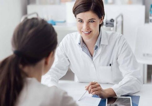 A woman consulting other woman wearing white