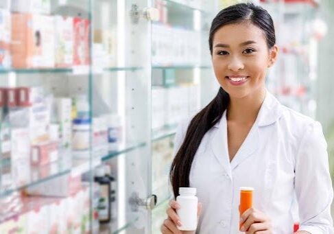 A woman standing wearing white in a medicine shop