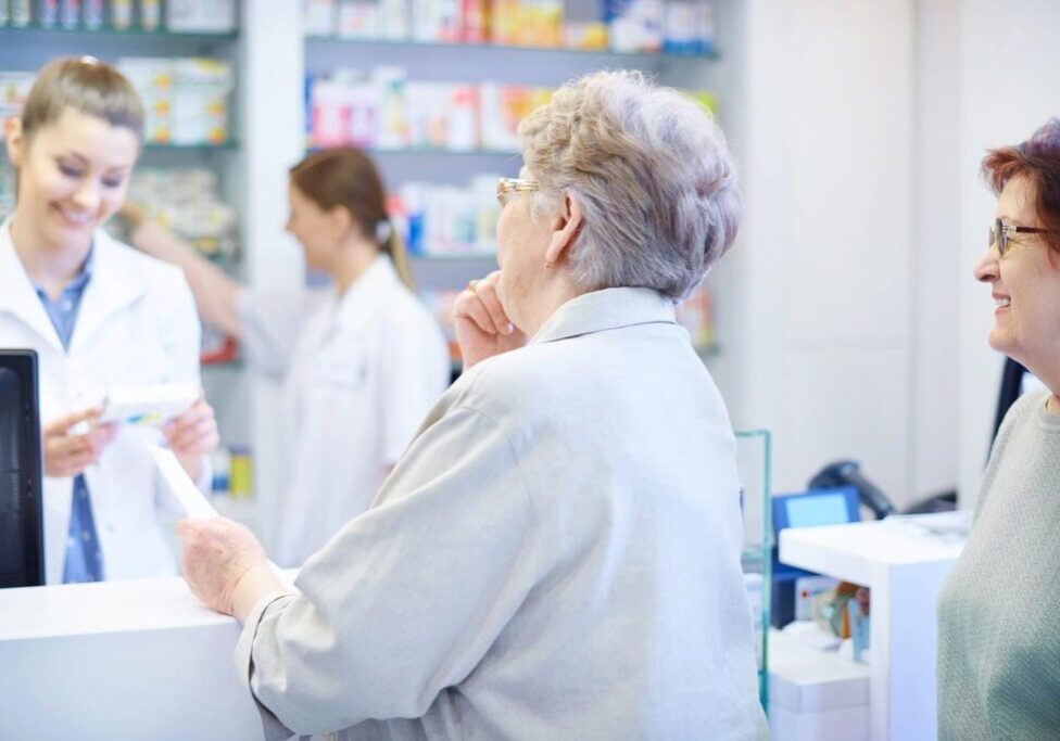 A woman is standing in front of some shelves.